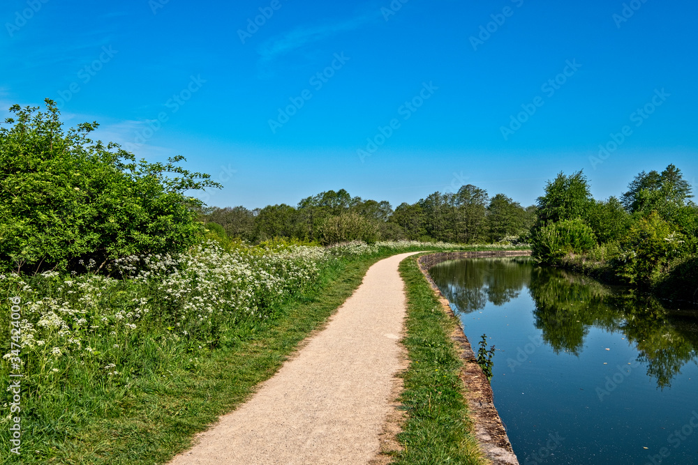 Restored towpath with Trent and Mersey canal in Cheshire UK