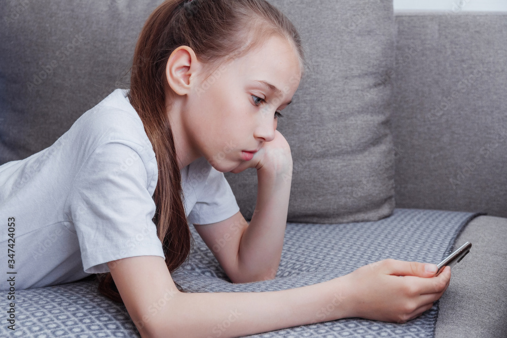 A sad girl is watching an informational video A sad girl is watching an informational video