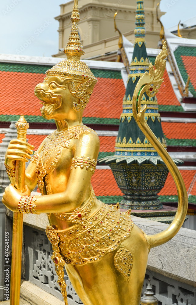 Fototapeta premium Lion Guard sculpture at Wat Arun Tample with golden surface in Bangkok background