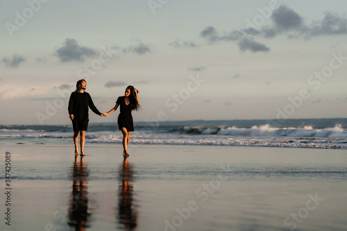 Young couple in love, Attractive man and woman enjoying romantic evening on sunset