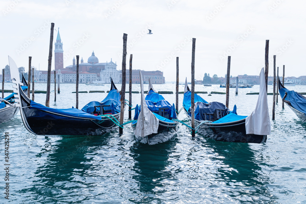 Fresh morning view on empty gondolas in the lagoon of Venice, Italy