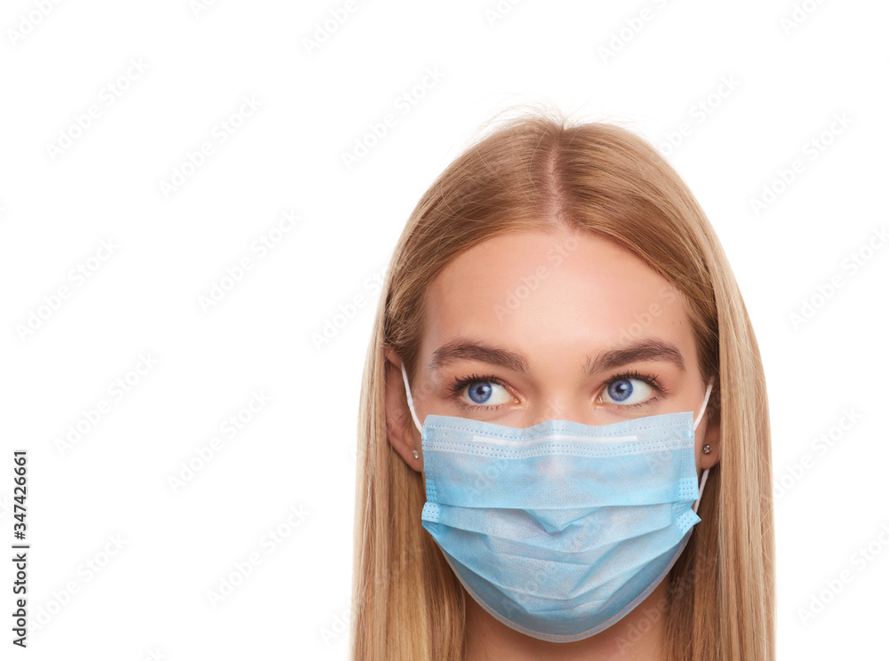 female face in a medical mask with eyes looks away female face in a medical mask with eyes looks away