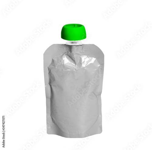 White empty plastic doy pack with spout and round green lid, for baby food, fruit puree, snack on the go, isolated on a white background