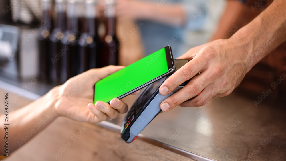 Young Woman is Using Her Smartphone with Green Screen for Contactless Payment. She is Paying for Gourme Street Food. Eco Friendly Gluten Free Food Court Selling Modern Fusion Cuisine Young Woman is Using Her Smartphone with Green Screen for Contactless Payment. She is Paying for Gourme Street Food. Eco Friendly Gluten Free Food Court Selling Modern Fusion Cuisine