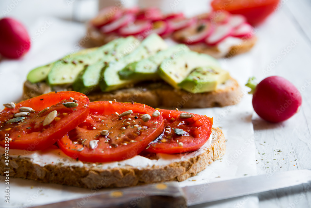 Vegetable sandwiches with radish, avocado and tomato, healthy vegan snack
