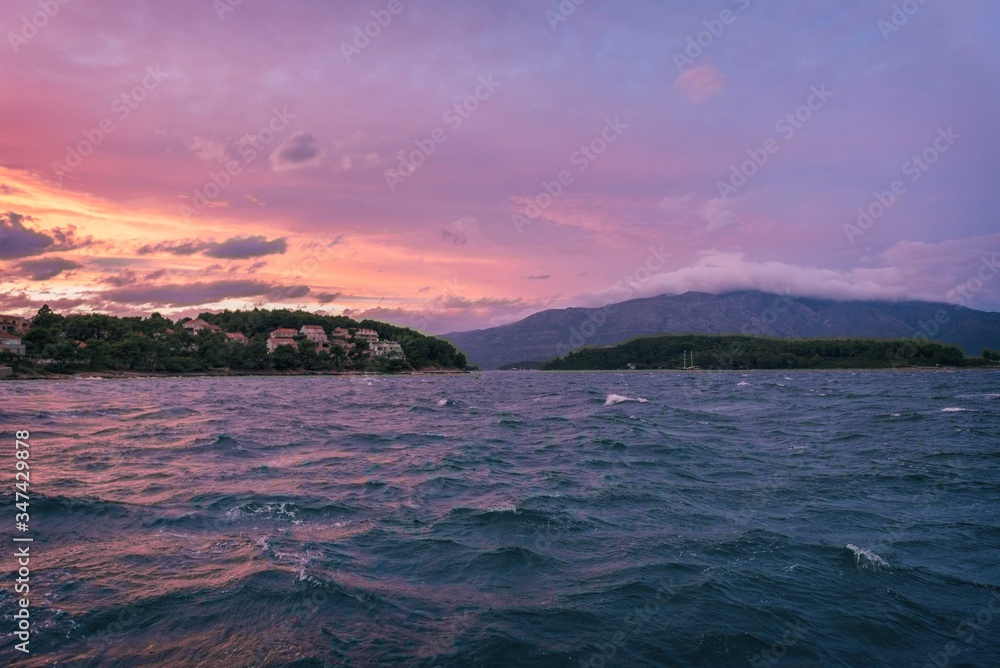 Sailing sunset on adriatic sea Makarska Korcula Croatia. Yacht in marina, sailing in Croatia.
