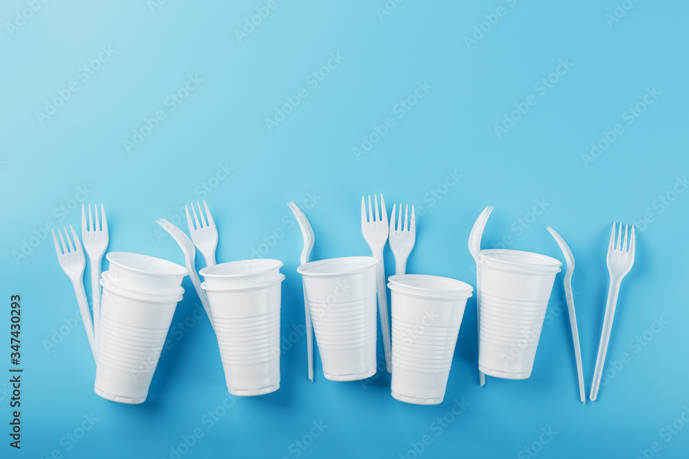 Dishes made of white plastic on a blue background. Dishes made of white plastic on a blue background.