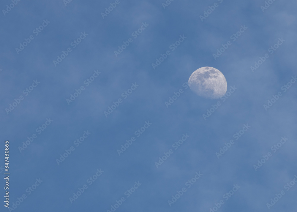 almost full moon in the blue sky almost full moon in the blue sky