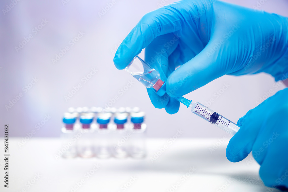 Close up on vaccine and medical syringe Close up on vaccine and medical syringe