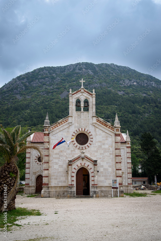 Church in front of the mountain, in Ston, Dubrovnik Neretva county, located on the Peljesac peninsula, Croatia, Europe.