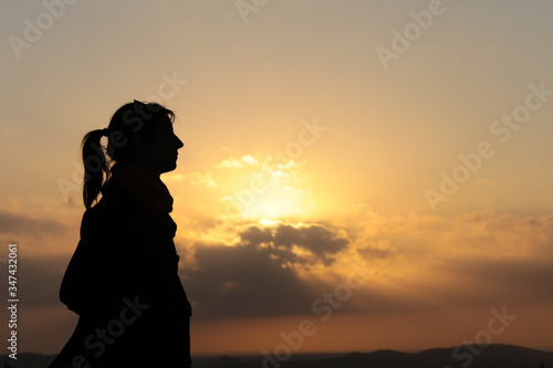 Silhouette of a woman profile at sunset
