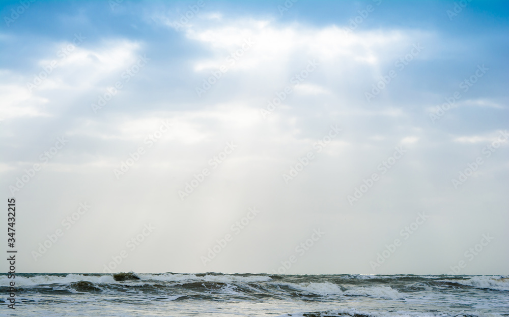 Sunshine pouring over the sea  through the clouds view from beach of somnath temple Gujarat India
