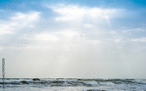 Sunshine pouring over the sea  through the clouds view from beach of somnath temple Gujarat India 