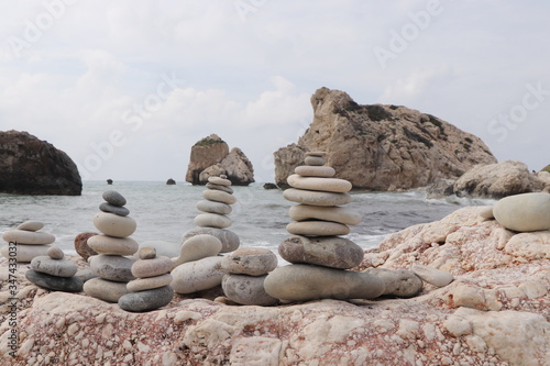 Famous Afroditi beach in Cyprus. Constructions of stones Opposite Aphrodite hill. Forbidden bathing. Childhood. Wonderful pyramid from pebble stones. Morning times. Mother of nature