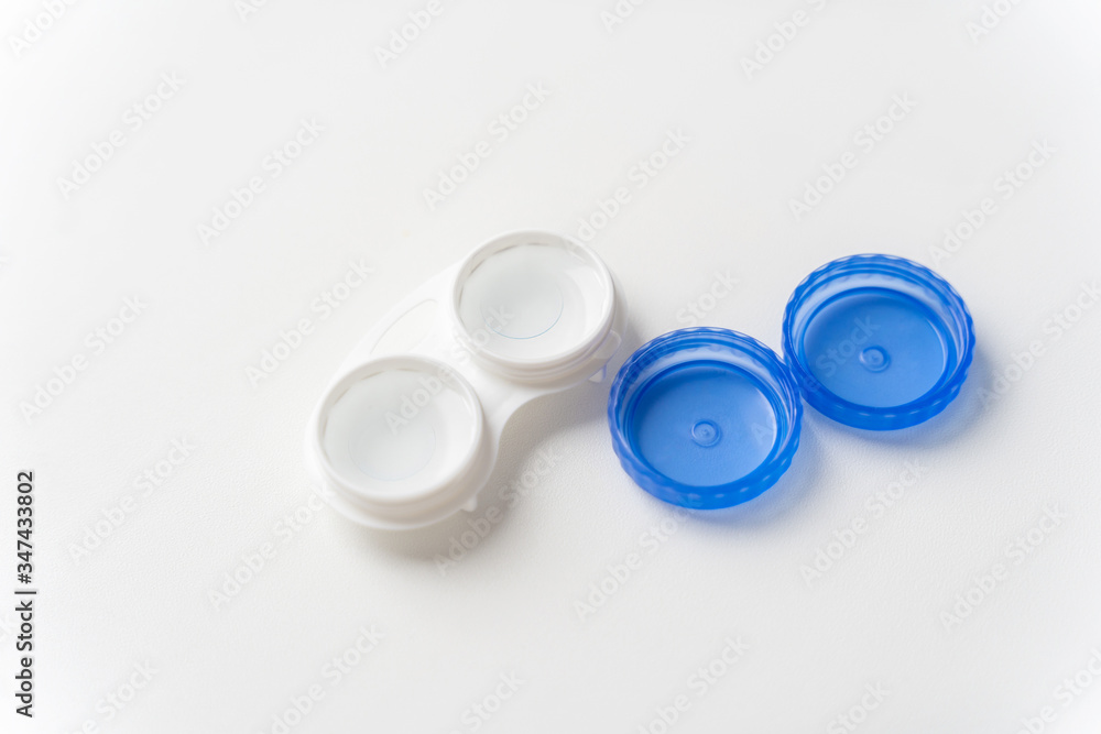 Contact lenses are in solution in the contact lens container on a light background. Contact lenses for correcting vision. Contact lenses are in solution in the contact lens container on a light background. Contact lenses for correcting vision.