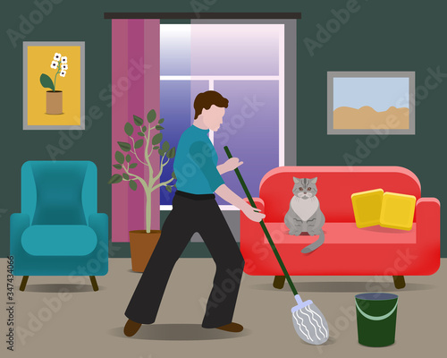 Man washes the floor in the living room. House cleaning. The cat is sitting on the couch