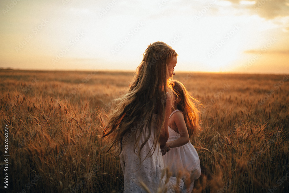 two girls run on a wheat field two girls run on a wheat field