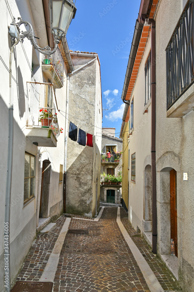 Fototapeta premium A narrow street between the old houses of the village of Pietraroja, in the province of Benevento, Italy