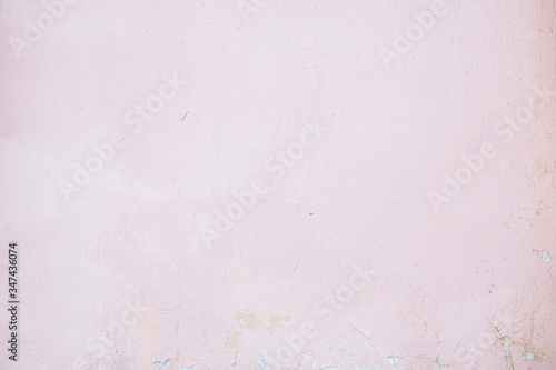 Pink concrete wall with chipped and scratches. Aged texture and background