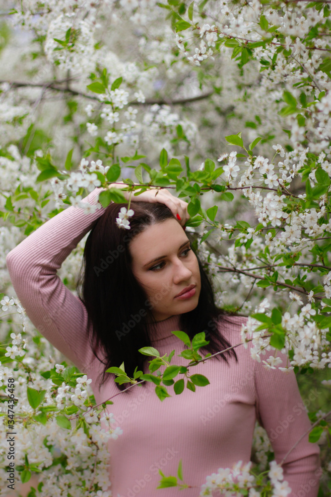 portrait of a young girl in a blossoming apple tree portrait of a young girl in a blossoming apple tree