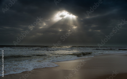 Sunshine pouring over the sea  through the clouds view from beach of somnath temple Gujarat India 