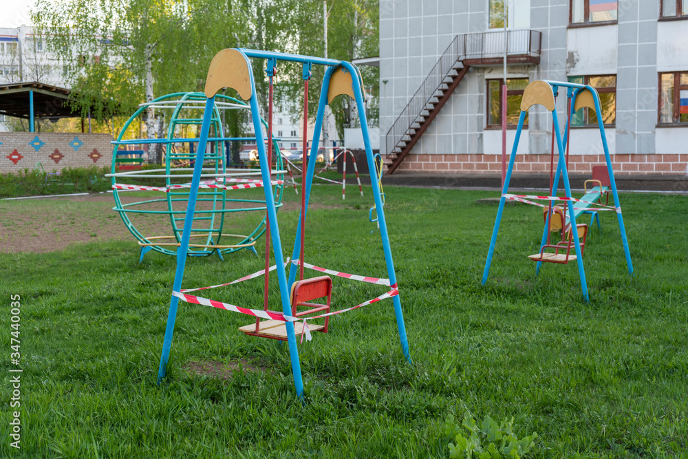 No entry barrier tape in a playground, due to the quarantine restrictions activated to combat the Coronavirus pandemic No entry barrier tape in a playground, due to the quarantine restrictions activated to combat the Coronavirus pandemic