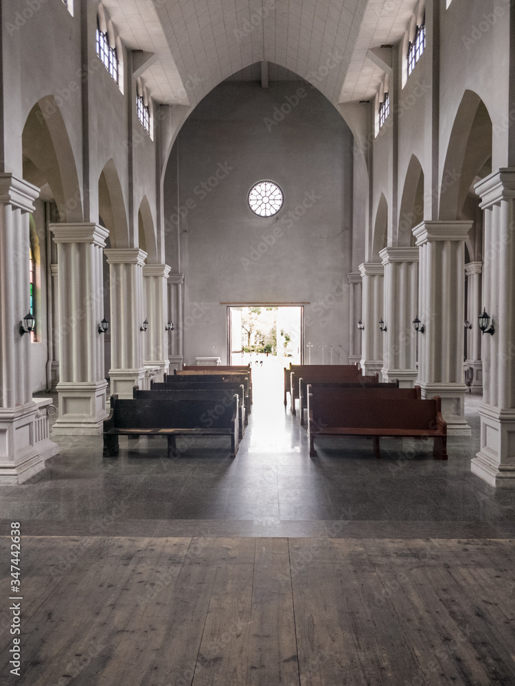 Fototapeta premium interior of church from the altar looking back past the pews through the entrance doors