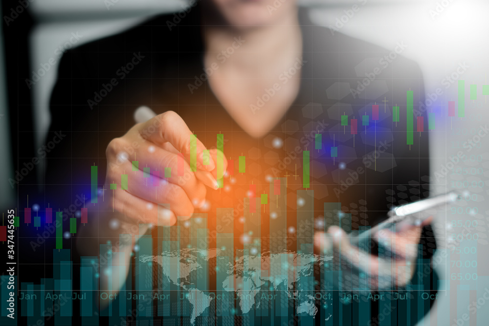 Businesswoman using writing and mobile phone on business financial data. Analyzing financial data and stock graph. Analysis of numerical data and stock market communication with businesses worldwide. Businesswoman using writing and mobile phone on business financial data. Analyzing financial data and stock graph. Analysis of numerical data and stock market communication with businesses worldwide.