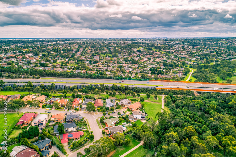 Aerial view of Eastlink tollway passing through suburbs in Melbourne, Australia