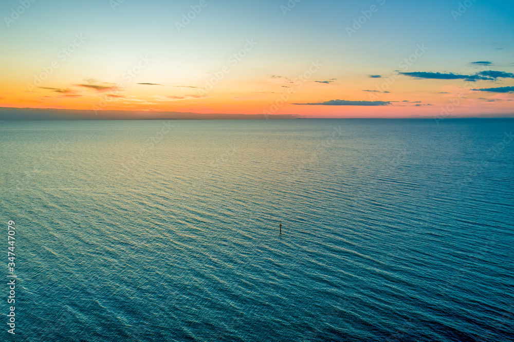 Beautiful minimalist seascape of dusk over water - aerial view with copy space