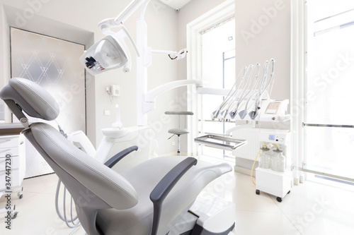 Dentist tools and professional dentistry chair in modern clinic