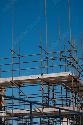 scaffolding building construction site against blue sky