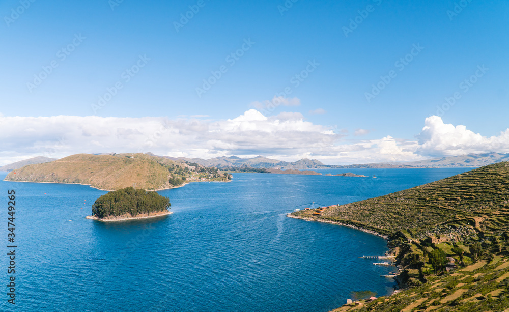Lake water Island, Bolivia. Scenic panoramic view of island and sea horizon. Bolivian Isla del Sol island paradise and hills. Tourist walking trail, arrival by boat. Local community, tourism. Titicaca