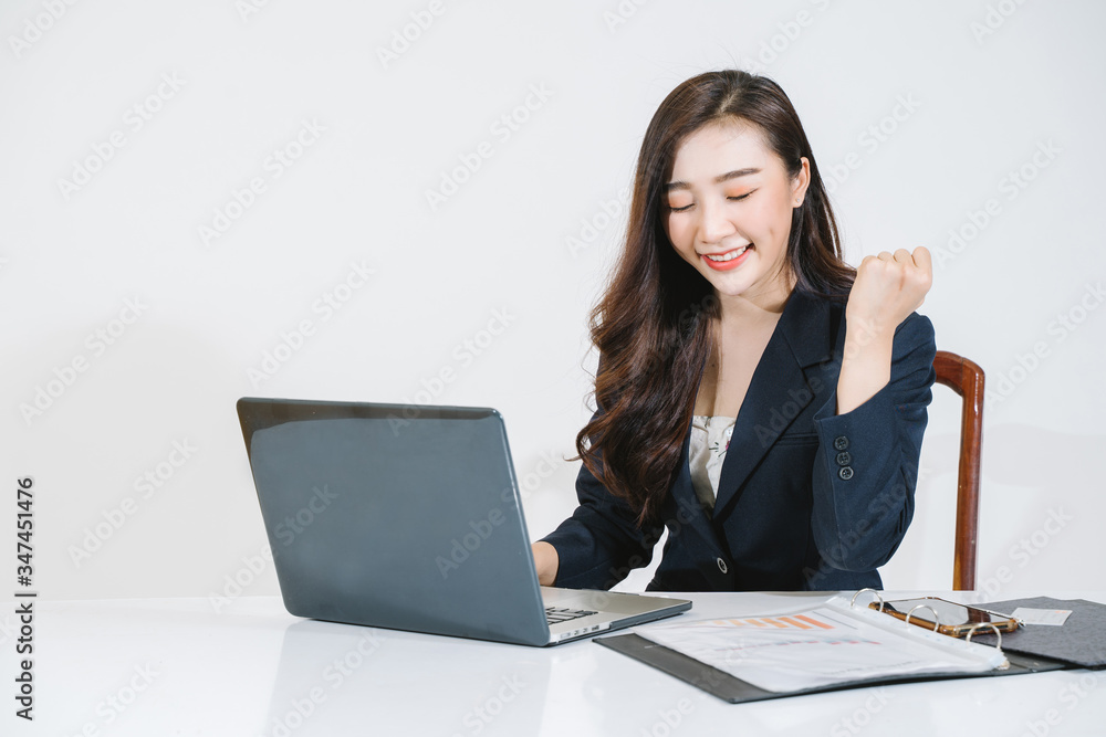 Successful girl manager in her own office makes a new economic development business plan on a laptop . A business woman with documents sits at a wooden table Successful girl manager in her own office makes a new economic development business plan on a laptop . A business woman with documents sits at a wooden table