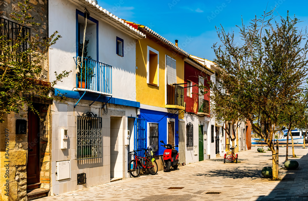 View of colorful homes near the ocean in picturesque town of Denia in southern Spain.