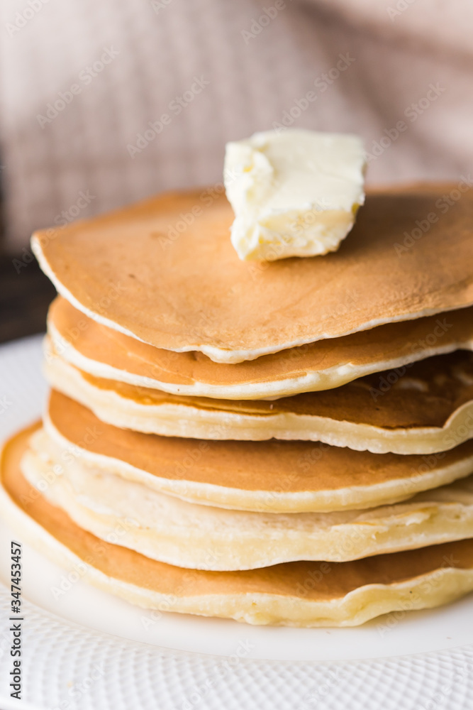 Pile of tasty pancakes with butter. Breakfast concept.