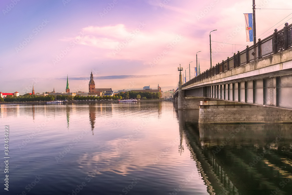 Skyline of Riga and the river Daugava in the morning,  Latvia. Riga castle, St. Saviour's Anglican Church, Church of St. Jacob, Dome cathedral, Stone bridge (from left to right). Delicate pink morning