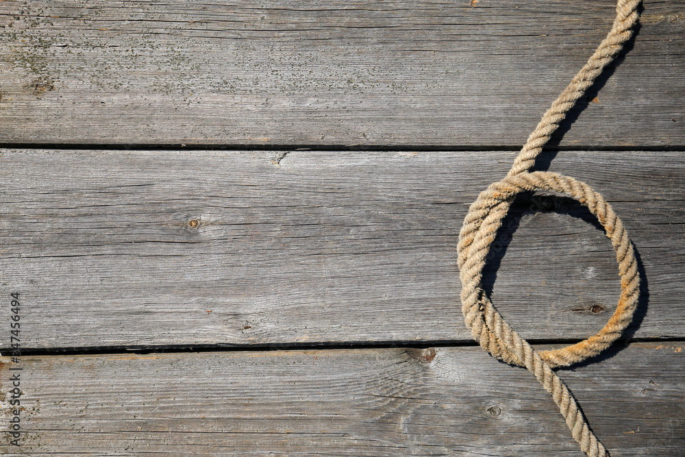 Obraz premium Ship rope on old wooden texture background with copy space
