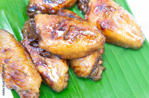Chicken wings with cola sauce on green background