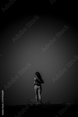 Frau mit langen Haaren auf einer Strasse mit low key technik