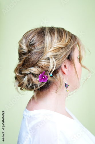 Hairstyle with a purple flower