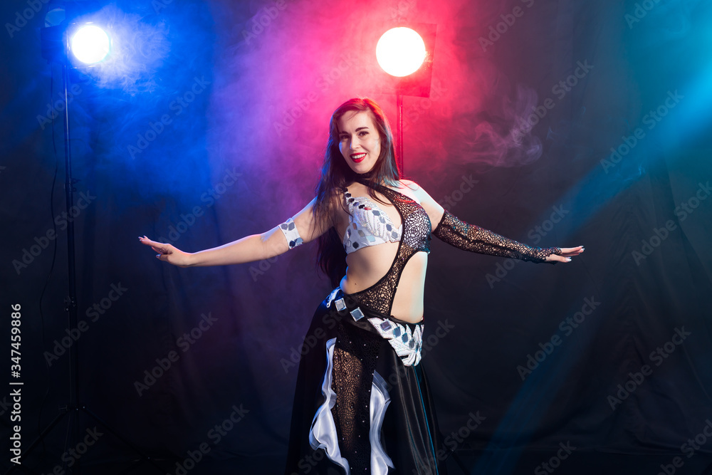 Portrait of a woman in oriental costume performing belly dance. Tribal fusion dance concept.