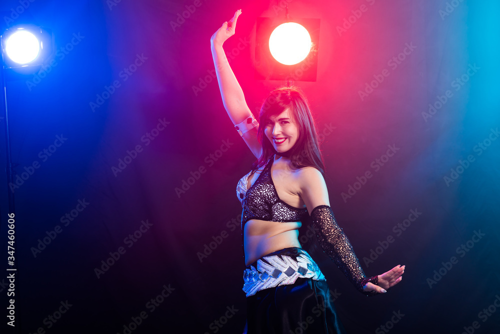 Portrait of a woman in oriental costume performing belly dance. Tribal fusion dance concept. Copy space. Portrait of a woman in oriental costume performing belly dance. Tribal fusion dance concept. Copy space.