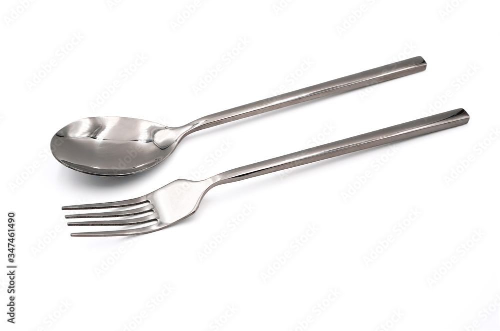 pair of new and shiny stainless spoon and fork isolated on white background , kitchenware or utensils concept