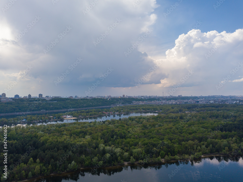 Rain clouds over the Dnieper River in Kiev. Aerial drone view.