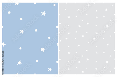 White Freehand Dots and Stars Isolated on a Pastel Blue and Light Gray Background. Starry Seamlles Vector Pattern. Funny Night Sky Repeatable Print. Irregular Hand Drawn Stars Backdrop. photo