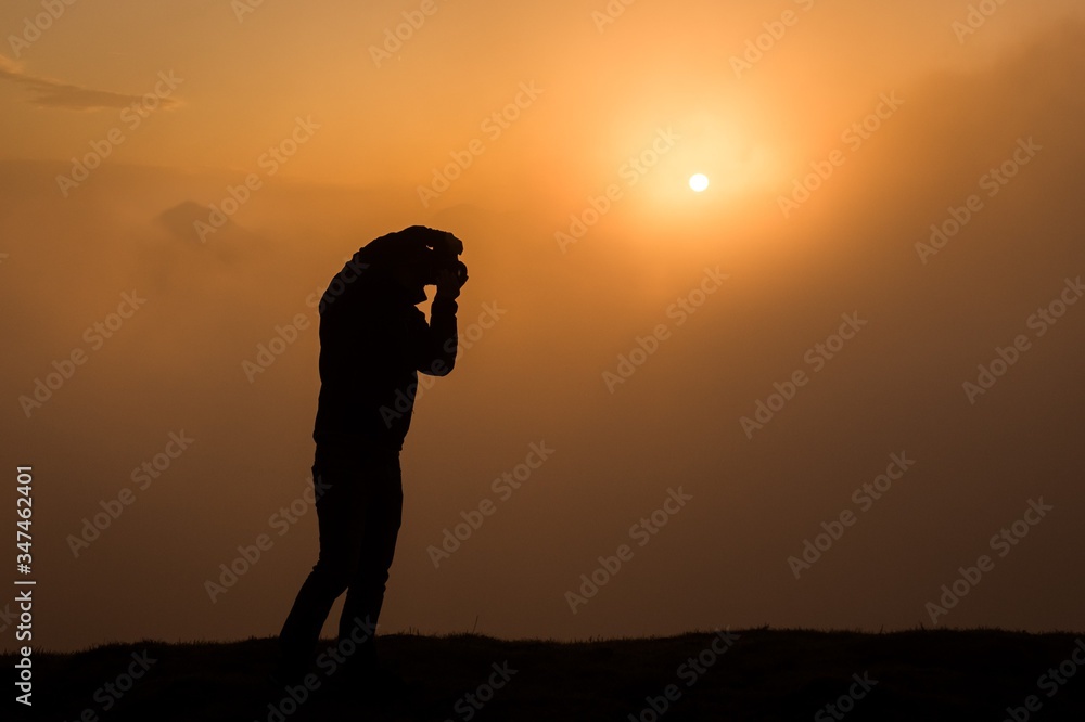 A photographer on the sunrise mountain