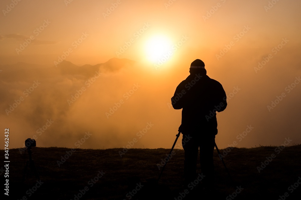 A mountain sunrise with a photographer A mountain sunrise with a photographer