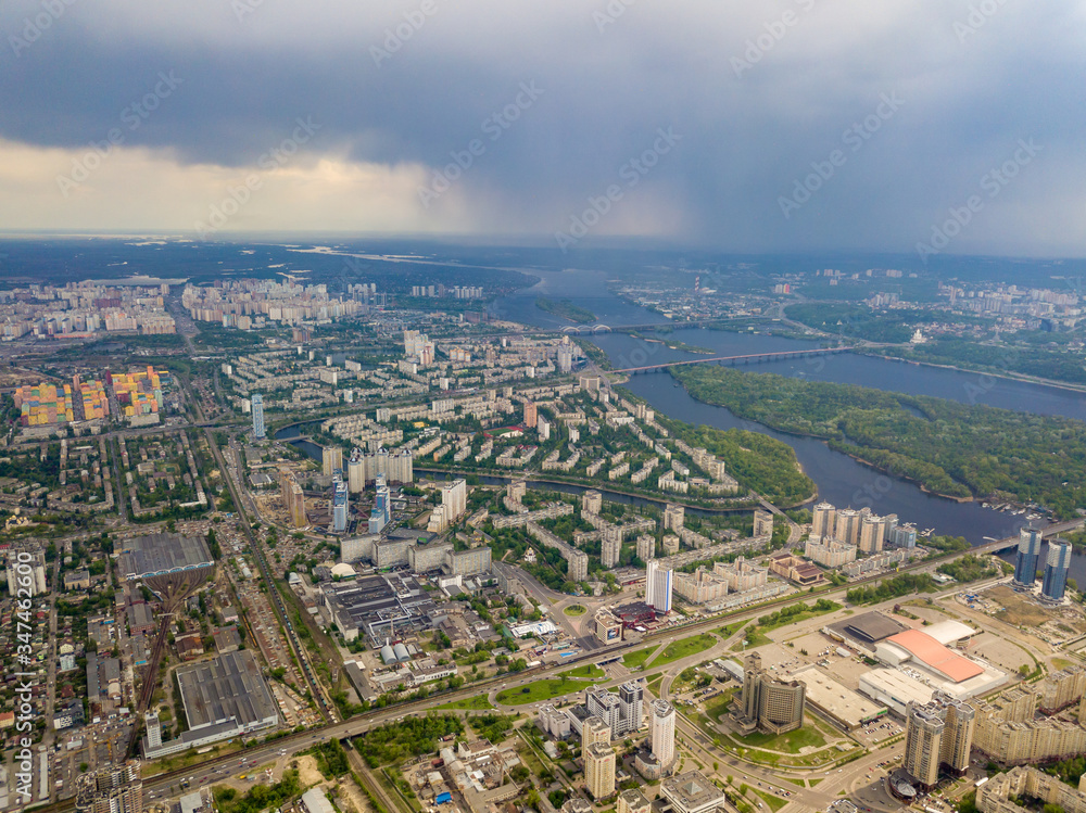 Spring rain over Kiev. There are black thunderclouds in the sky, dark rain falls on the city. Aerial drone view. Spring rain over Kiev. There are black thunderclouds in the sky, dark rain falls on the city. Aerial drone view.