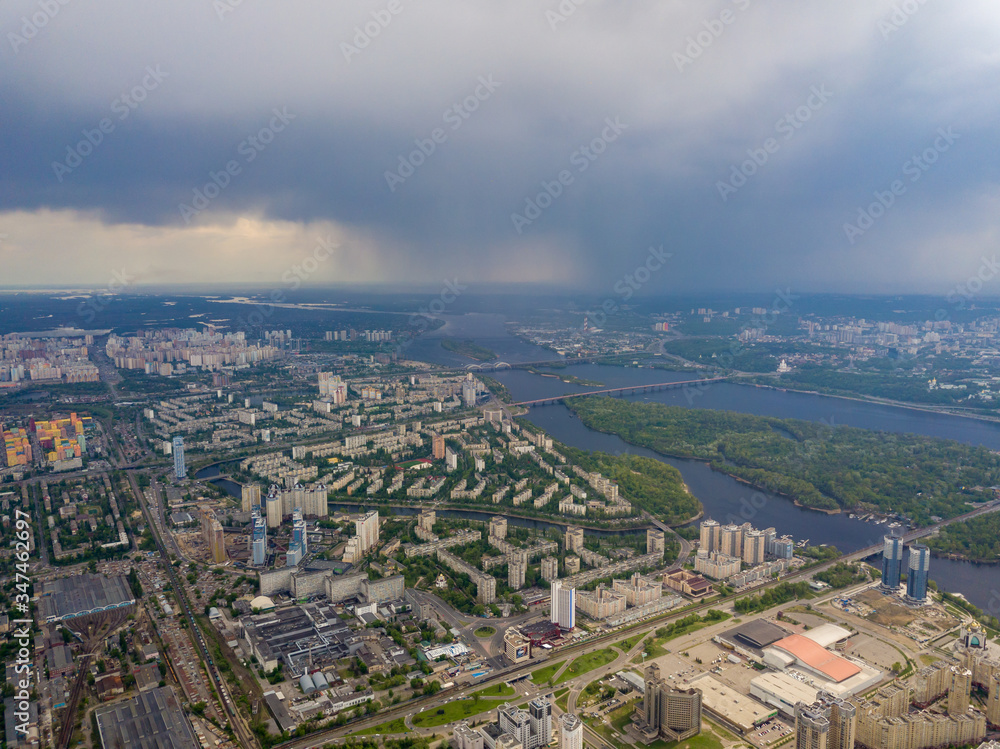 Spring rain over Kiev. There are black thunderclouds in the sky, dark rain falls on the city. Aerial drone view.